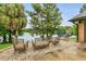 Rear patio offers comfortable seating with a view of the lake and mature trees at 3501 Danby Ct, Orlando, FL 32812
