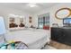 Well-lit bedroom featuring twin beds, mirrored closet doors, and a neutral color palette at 3501 Danby Ct, Orlando, FL 32812