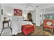 Inviting bedroom with comfortable bed, red accent chair, and plenty of natural light at 3501 Danby Ct, Orlando, FL 32812