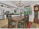 Dining room with wood table, chandelier, patterned rug, and view of the kitchen at 3501 Danby Ct, Orlando, FL 32812