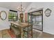Cozy dining room features a chandelier, decorative rug, and sliding glass doors to the outdoor patio at 3501 Danby Ct, Orlando, FL 32812