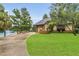 Charming home with a well-maintained front yard, two-car garage, and access to an adjacent lake at 3501 Danby Ct, Orlando, FL 32812