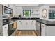 Bright kitchen featuring stainless appliances, white cabinets, and a view of the sink and window at 3501 Danby Ct, Orlando, FL 32812