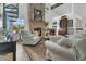 Bright living room with a brick fireplace, spiral staircase, and large windows offering natural light at 3501 Danby Ct, Orlando, FL 32812