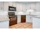 Modern kitchen with stainless steel appliances, granite countertops, and a tile backsplash at 357 Fairway Pointe Cir, Orlando, FL 32828