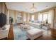 Bright living room with hardwood floors, large windows, and a comfortable seating area at 357 Fairway Pointe Cir, Orlando, FL 32828