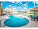 Screened in pool area with clear blue water, ample deck space, and outdoor seating at 357 Fairway Pointe Cir, Orlando, FL 32828