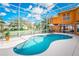 Enclosed pool with screen surround, offering a luxurious outdoor living space with table, chairs and a well landscaped lawn at 357 Fairway Pointe Cir, Orlando, FL 32828