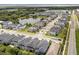 An aerial view showcases the community's layout, featuring modern homes and a scenic pond, all set against a backdrop of lush greenery at 3804 Corona Ct, Sanford, FL 32773
