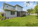 Spacious backyard with a screened-in lanai, lush lawn and a black metal fence surrounding the perimeter at 3804 Corona Ct, Sanford, FL 32773