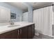 A well lit bathroom with a single vanity, large mirror, shower, and modern fixtures at 3804 Corona Ct, Sanford, FL 32773