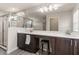 Modern bathroom featuring dual sinks, stylish wood cabinets, vanity seating and a separate glass-enclosed shower at 3804 Corona Ct, Sanford, FL 32773