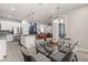 Open-concept layout of dining area featuring a glass table and view of the stairs and living room at 3804 Corona Ct, Sanford, FL 32773