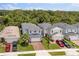 Aerial view of homes with brick paver driveways, attached garages, and manicured lawns in a treed community at 3804 Corona Ct, Sanford, FL 32773