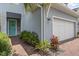 Exterior view of the front of the house with a turquoise door and brick walkway at 3804 Corona Ct, Sanford, FL 32773