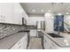 Modern kitchen featuring white cabinets, stainless steel appliances, gray countertop, and stylish backsplash at 3804 Corona Ct, Sanford, FL 32773