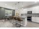 Modern kitchen featuring a center island with bar seating, stainless steel appliances, and pendant lighting at 3804 Corona Ct, Sanford, FL 32773