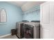 Bright laundry room with modern appliances, shelving, and ample space for folding at 3804 Corona Ct, Sanford, FL 32773