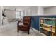 A comfortable upstairs living room featuring a blue accent wall, television, and cozy seating at 3804 Corona Ct, Sanford, FL 32773