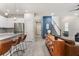 Open living space with views of the kitchen, a striking blue accent wall, and staircase at 3804 Corona Ct, Sanford, FL 32773
