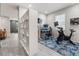 Home office with two monitors and workout bike, alongside modern white shelving and natural lighting at 3804 Corona Ct, Sanford, FL 32773