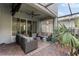 Covered patio area with comfortable seating, ceiling fan, and sliding glass doors leading indoors at 3804 Corona Ct, Sanford, FL 32773