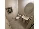 This bathroom features a white toilet, sink, decorative mirror and tiled flooring at 3963 Turow Ln, Orlando, FL 32828