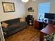 This bedroom is furnished with a sofa, desk, computer, and a window with blinds at 3963 Turow Ln, Orlando, FL 32828