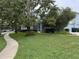 A charming home with a lush green lawn and mature trees, perfect for outdoor enjoyment at 3963 Turow Ln, Orlando, FL 32828