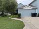 Charming home featuring a two-car garage, well-maintained lawn, and neat landscaping, showcasing curb appeal at 3963 Turow Ln, Orlando, FL 32828