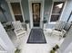 Inviting front porch with chairs, a rug, and decor creating a cozy and welcoming entryway at 3963 Turow Ln, Orlando, FL 32828