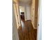 Hallway with wood floors leading to an office with built-in desk and storage at 3963 Turow Ln, Orlando, FL 32828