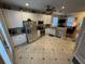 Modern kitchen boasts white cabinets, stainless steel appliances, and a functional layout for cooking and dining at 3963 Turow Ln, Orlando, FL 32828