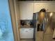 Kitchen area featuring white cabinets, granite countertops, and stainless steel refrigerator at 3963 Turow Ln, Orlando, FL 32828