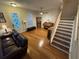 Comfortable living room with hardwood floors, a sofa, and a staircase leading to the upper level at 3963 Turow Ln, Orlando, FL 32828