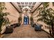 A grand lobby with high ceilings, chandelier lighting, comfortable seating, and potted plants at 3963 Turow Ln, Orlando, FL 32828