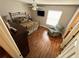Cozy main bedroom featuring wood floors, a ceiling fan, TV, and relaxing chair at 3963 Turow Ln, Orlando, FL 32828