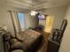 Cozy main bedroom featuring wood floors, a ceiling fan, TV, and ensuite bathroom access at 3963 Turow Ln, Orlando, FL 32828