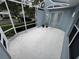 Enclosed patio with concrete flooring, white railings, and access to the outside at 3963 Turow Ln, Orlando, FL 32828