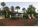 Community playground featuring swings, slides, and a play structure, set amidst lush landscaping and mature palm trees at 3963 Turow Ln, Orlando, FL 32828