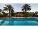 A large pool with palm trees in the background at 3963 Turow Ln, Orlando, FL 32828