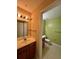 View of powder room with tiled floors, toilet and sink with wood cabinets in neutral tones at 4010 Santa Maria Dr # 106, Kissimmee, FL 34741