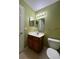 Bathroom with a vanity sink, mirror, and toilet at 4010 Santa Maria Dr # 106, Kissimmee, FL 34741