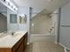Bright bathroom with a tub and shower and a large mirror at 4010 Santa Maria Dr # 106, Kissimmee, FL 34741