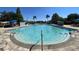 Large community pool with a zero entry and several lounge chairs and umbrellas at 4010 Santa Maria Dr # 106, Kissimmee, FL 34741