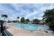 Large community pool with lounge chairs, umbrellas, and palm trees at 4010 Santa Maria Dr # 106, Kissimmee, FL 34741
