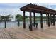 Waterfront community lake and pergola covered dock with seating at 4010 Santa Maria Dr # 106, Kissimmee, FL 34741