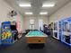 Community game room featuring a pool table, arcade games, and prize machines at 4010 Santa Maria Dr # 106, Kissimmee, FL 34741