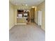 Open living room with adjacent kitchen, carpeted floors and bright lighting for easy living at 4010 Santa Maria Dr # 106, Kissimmee, FL 34741