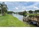 Scenic community pond with a fountain, lush landscaping, and a wooden dock for residents at 4010 Santa Maria Dr # 106, Kissimmee, FL 34741